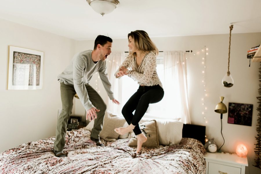 man and woman jumping on bed, Romantic in Home Anniversary Session