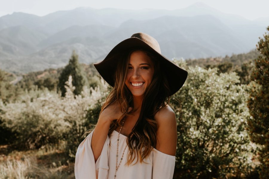 teenage girl fashion, girl smiling on mountain side, Garden of the Gods Senior Pictures in Colorado 