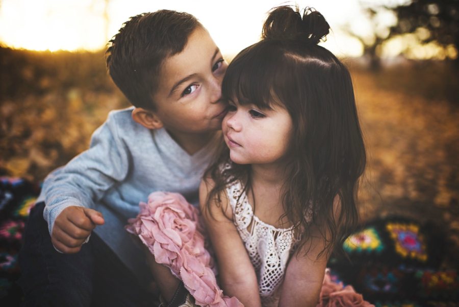 brother giving sister kiss on the cheek, Sunset Family Pictures in Colorado