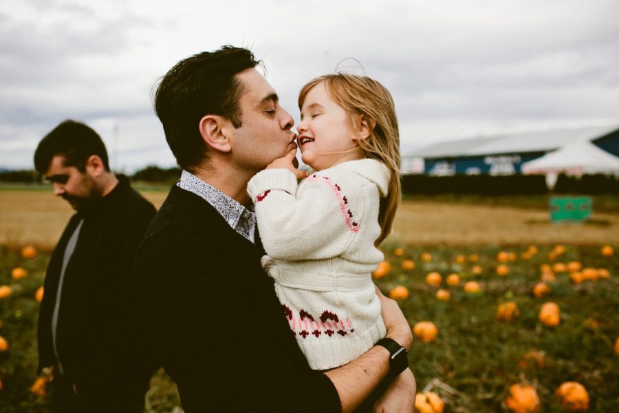 dad giving kisses to daughter, lifestyle photography, Family Pumpkin Patch Adventure in British Columbia