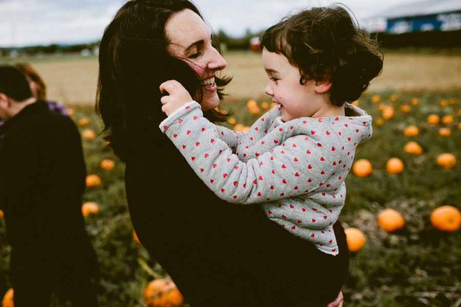 mom holding daughter, lifestyle photography, Family Pumpkin Patch Adventure in British Columbia