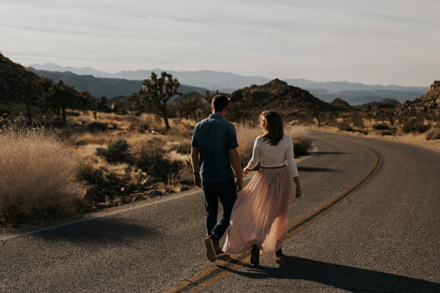 man and woman walking in road, Moody Couples Session at Joshua Tree
