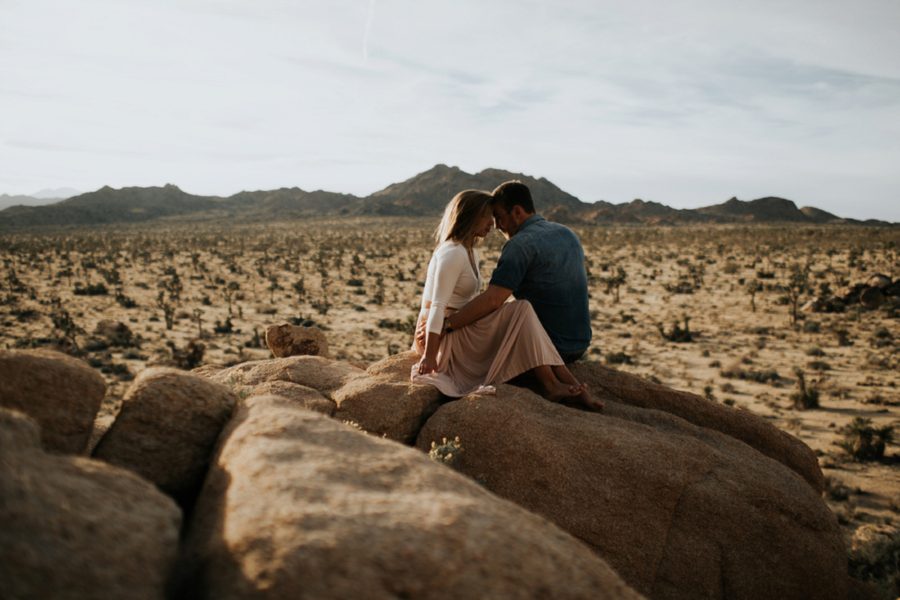 man and woman forehead touching, mountain engagement photos, Moody Couples Session at Joshua Tree