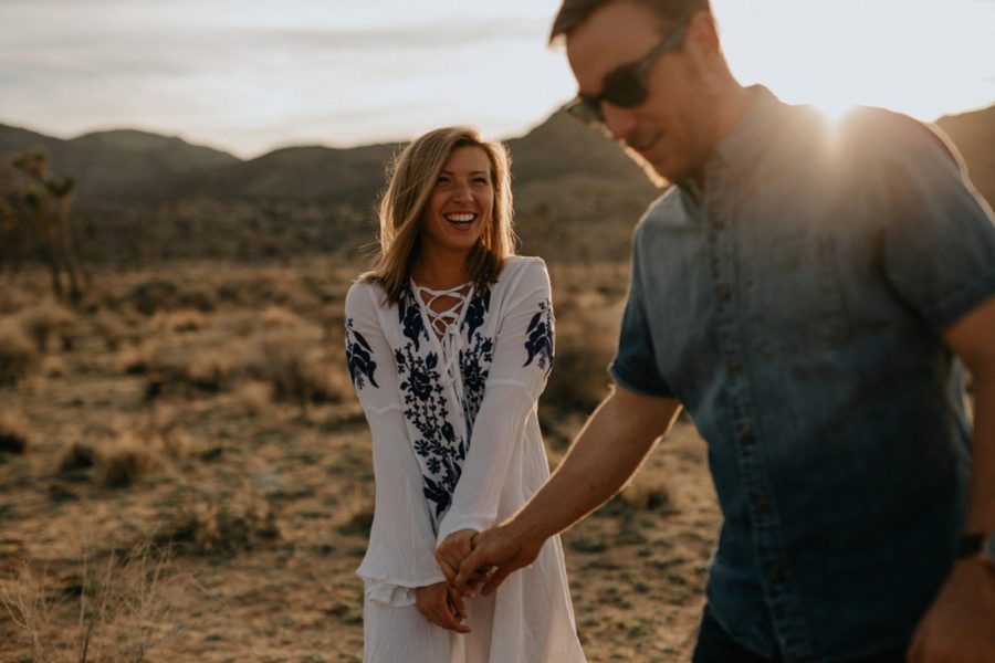 woman smiling at man, couple in desert, Moody Couples Session at Joshua Tree