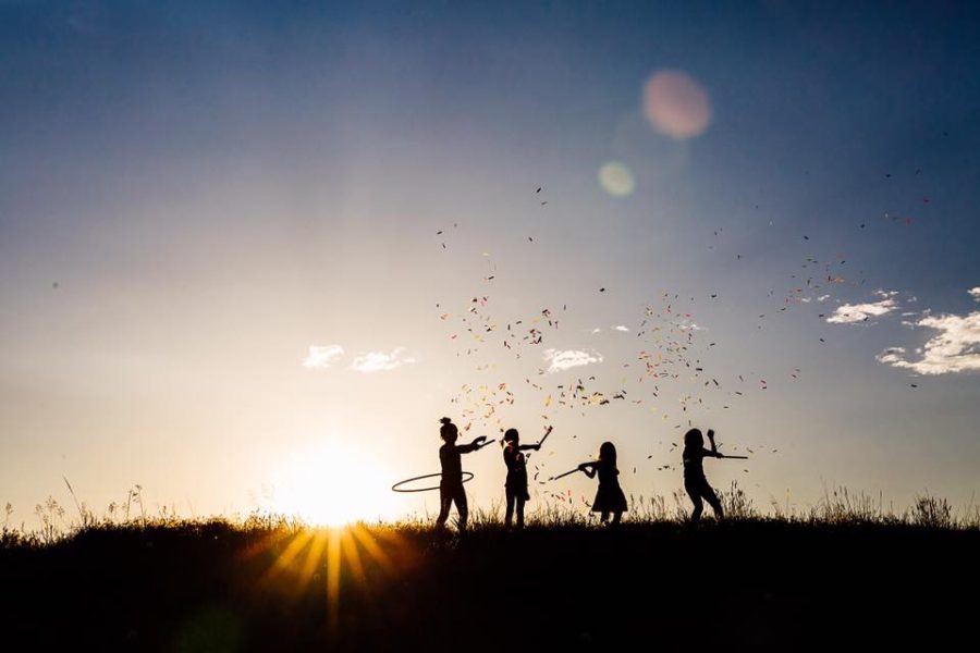 silhouette of children, big sky, child hula hooping