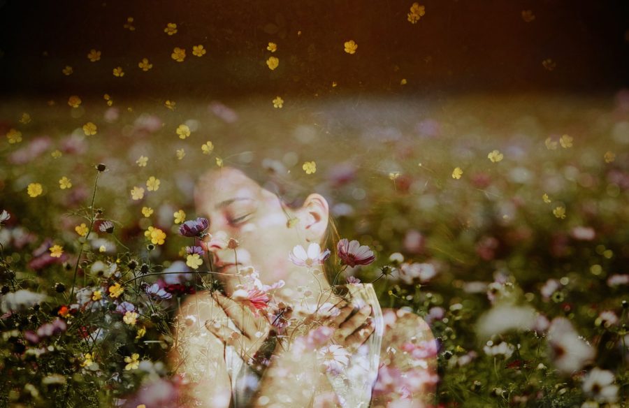 girl laying in flowers, double exposure with flowers