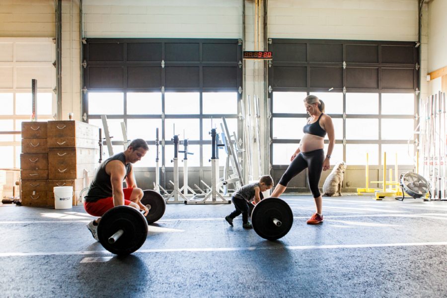 Man about to lift barbell, family at the gym, Documentary Maternity Pictures at Crossfit Gym