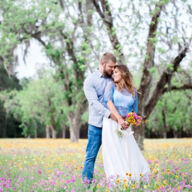 Couple standing in field with flowers, Engagment posing inspiration, Organic Engagement Pictures in Florida Wildflower Field