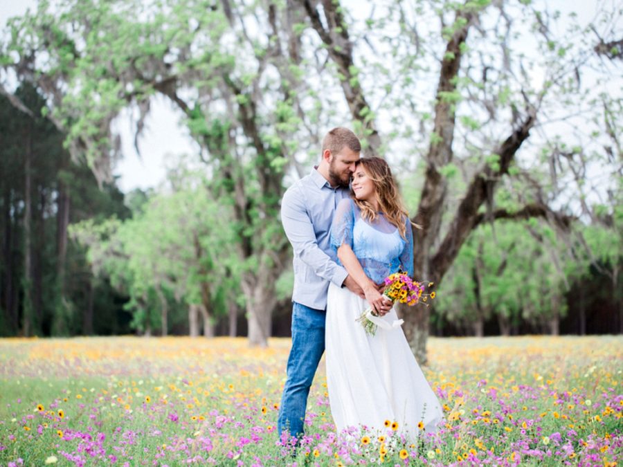 Couple snuggling in field, Engagment posing inspiration, Organic Engagement Pictures in Florida Wildflower Field