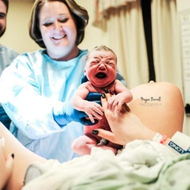 Baby being held up right after birth, Megan Burrell Photography Daily Fan Favorite