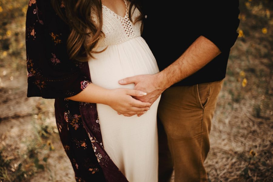 Hands on belly, Moody Sunflower Maternity Session in Colorado