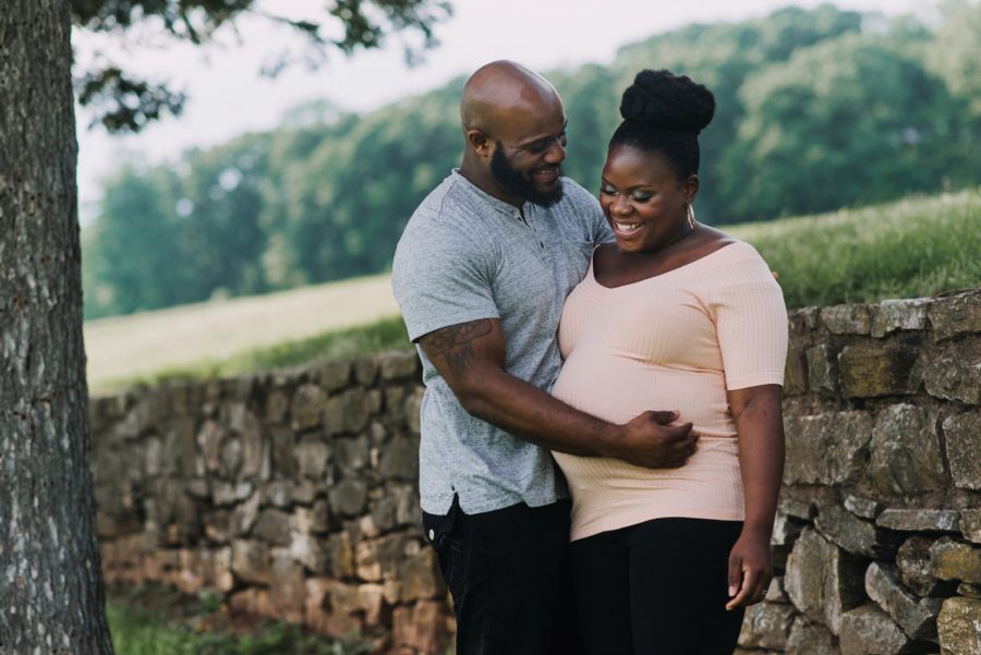 Man and woman smiling outside during maternity photos, Classy Outdoor Maternity Session in Philadelphia
