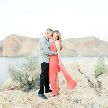 Couple on rocks overlooking lake, Canyon Lake Engagement Pictures in Arizona