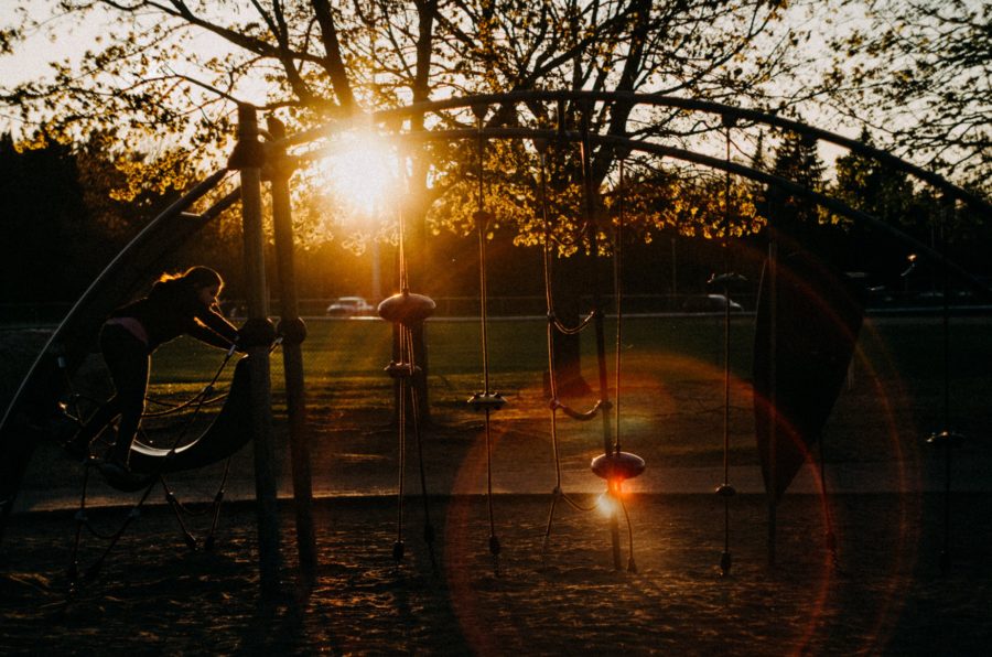 Child climbing on playground at sunset, Beyond the Wanderlust Daily Fan Favorite