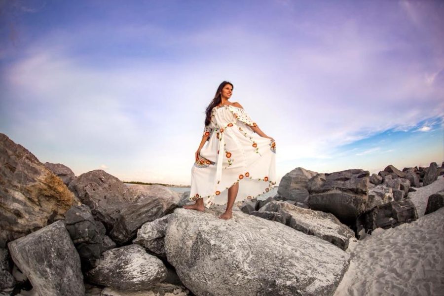 Woman standing rocks at beach under pretty sky, Beyond the Wanderlust Daily Fan Favorite 