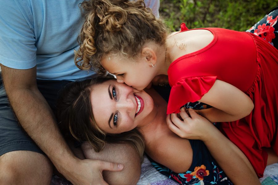 Overhead picture of family mom looking at camera daughter kissing cheek, Courtney Venable Photography Daily Fan Favorite 
