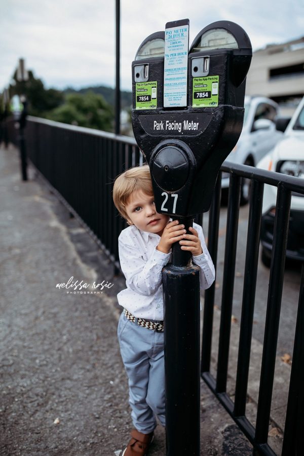 Boy peeking out from behind parking meter, Beyond the Wanderlust Daily Fan Favorite