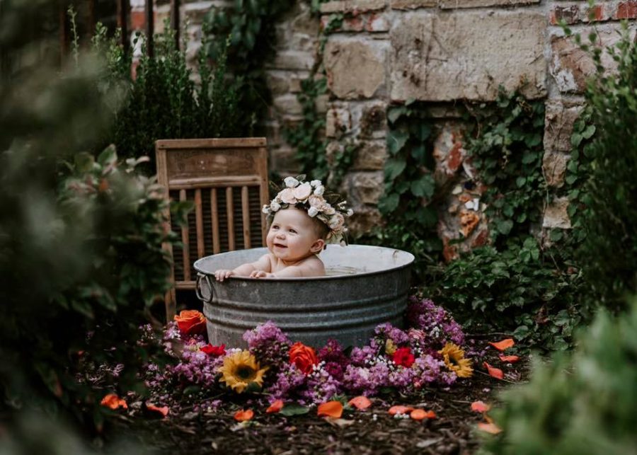 Baby with flower crown sittin gin tin bucket outside, Beyond the Wanderlust Daily Fan Favorites
