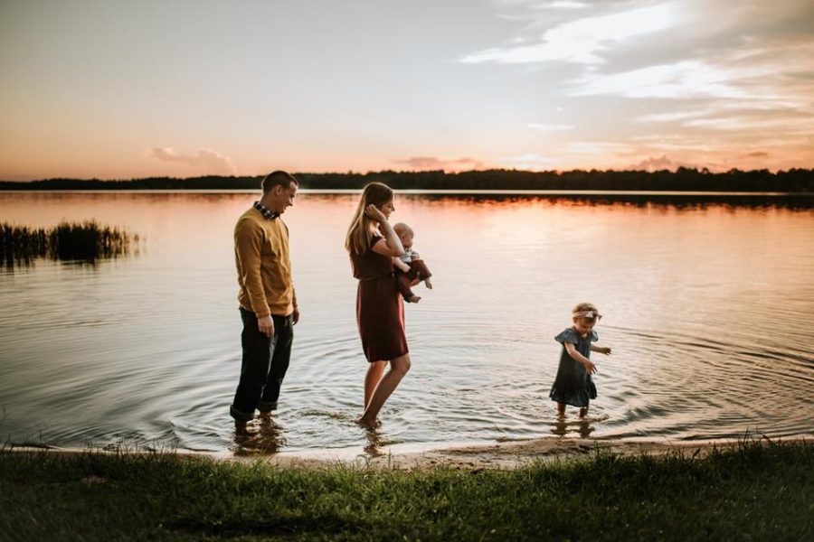 Family walking at edge of lake in water during sunset, Rebecca Fleming Photography Daily Fan Favorite