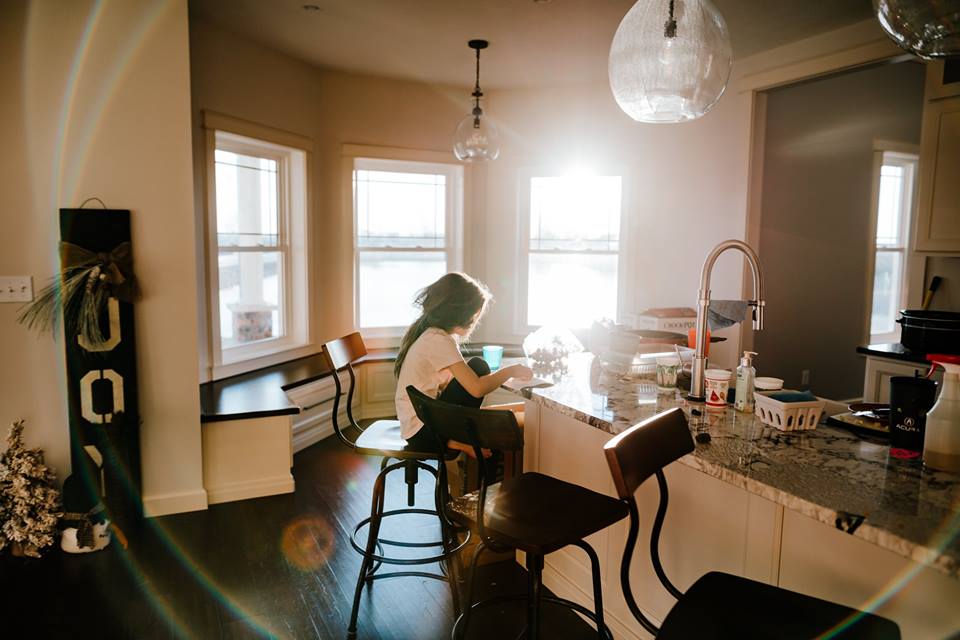 indoor natural light, light flare, young girl eating breakfast in morning light, lifestyle inhome pictures