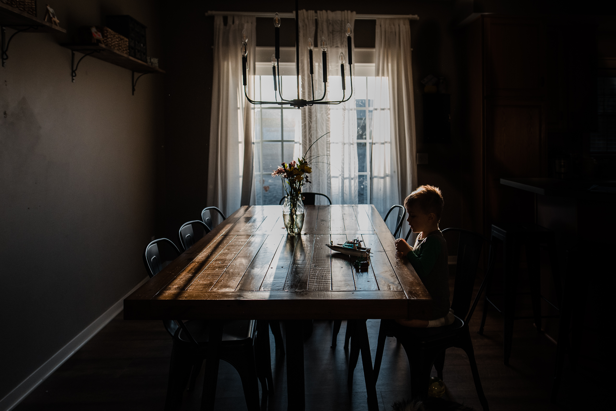 indoor natural light pictures, lifestyle kid pictures, boy sitting at table with natural light